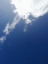 White clouds in the blue sky. Heaven and infinity. Beautiful bright blue background. Light cloudy, good weather. Royalty Free Stock Photo