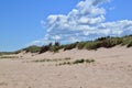 White clouds and blue sky over beach and dunes at PEI National Park Royalty Free Stock Photo