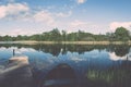 White clouds on the blue sky over blue lake with boats and board Royalty Free Stock Photo