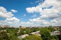 White clouds in the blue sky over the city and trees Clear blue sky with plain white cloud with space for text background Royalty Free Stock Photo