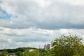 White clouds in the blue sky over the city and trees Clear blue sky with plain white cloud with space for text background Royalty Free Stock Photo