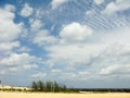 White clouds on the blue sky over country beach Royalty Free Stock Photo