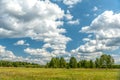 White clouds on blue sky over green forest Royalty Free Stock Photo