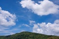 White clouds in blue sky over green mountains covered with rainforests trees Beautiful scenery view with blue sky and white clouds Royalty Free Stock Photo