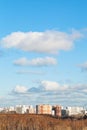 White clouds in blue sky over houses in autumn day Royalty Free Stock Photo
