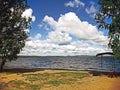 White clouds in the blue sky over the lake in the early morning Royalty Free Stock Photo