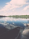 White clouds on the blue sky over blue lake with boats and board Royalty Free Stock Photo