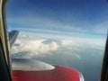 White clouds and blue sky seeng from the window of plane Royalty Free Stock Photo
