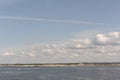 White clouds in the blue sky in Skagerrak Strait near StrÃÂ¶mstad between Sweden and Norway on a sunny day with navy blue sea