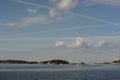 White clouds in the blue sky in Skagerrak Strait near StrÃÂ¶mstad between Sweden and Norway on a sunny day with navy blue sea