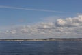 White clouds in the blue sky in Skagerrak Strait near StrÃÂ¶mstad between Sweden and Norway on a sunny day with navy blue sea