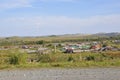 White clouds in the bright blue summer sky over village with small houses far away in the mountains and fields. Travelling. Peopl Royalty Free Stock Photo