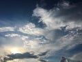 White clouds disappear in the hot sun on blue sky. Clouds on blue sky background. Weather nature blue sky with white cloud and sun Royalty Free Stock Photo