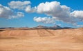 White clouds floating over dry grass land of plateau Royalty Free Stock Photo