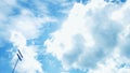 White clouds formation on a blue sky with floodlights on the left