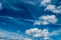 White clouds and haze against the blue sky. Condensation trail from an airplane flying at high altitude. Trail of water Royalty Free Stock Photo