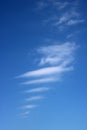 White clouds, white lines against blue sky Royalty Free Stock Photo