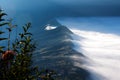 White clouds of mist covering village seen at a distance in the morning.