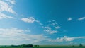 White Clouds Moving In Blue Sky. Floating White Fluffy Clouds In A Blue Sky And Field. Royalty Free Stock Photo