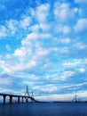 White clouds over blue sky at sunset over the Constitution Bridge