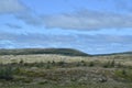 White clouds over rugged landscape along Newfoundland highway Royalty Free Stock Photo