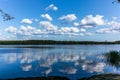 White clouds reflecting on the calm waters of the Saimaa lake in the Linnansaari National Park in Finland - 1 Royalty Free Stock Photo