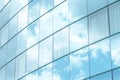 White clouds reflecting in simple modern generic office building square windows, skyscraper exterior, bright blue white background