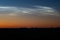 White clouds shining in the northern sky at night