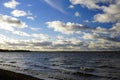White clouds. Windy day at the lake. Waves open spaces horizon. Autumn. November Royalty Free Stock Photo