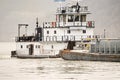 Coal barge going down the Ohio river under a bridge