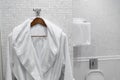 White coat on a hanger in the hotel bathroom Royalty Free Stock Photo