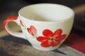 White cofee cup with red flower paint