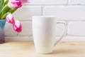 White coffee cappuccino mug mockup with magenta pink tulips Royalty Free Stock Photo