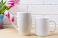 White coffee and cappuccino mug mockup with magenta tulip Royalty Free Stock Photo