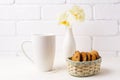 White coffee cappuccino mug mockup with soft yellow orchid in va Royalty Free Stock Photo