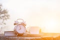 A white coffee cup and an alarm clock are placed beside the Bible on a wooden table in the morning to prepare for Bible study and Royalty Free Stock Photo