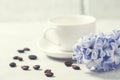 White coffee cup on a white background and flowers