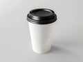 A white coffee cup with black lid on a gray background Royalty Free Stock Photo