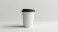 A white coffee cup with black lid on a table Royalty Free Stock Photo