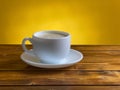 White coffee cup with cappuccino on wooden table Royalty Free Stock Photo