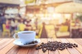 White coffee cup and coffee beans on wood table with blurred bac Royalty Free Stock Photo