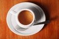 White coffee Cup with delicious foam, close-up top view on wooden background. Concept of coffee break and serving coffee Royalty Free Stock Photo