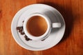 White coffee Cup with delicious foam, close-up top view on wooden background. Concept of coffee break and serving coffee Royalty Free Stock Photo