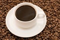 White coffee cup filled with coffee beans Royalty Free Stock Photo