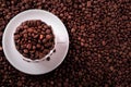White coffee cup filled with roasted beans top view Royalty Free Stock Photo