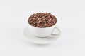 White coffee cup filled with whole coffee beans Royalty Free Stock Photo