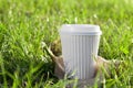 A white coffee cup in the grass