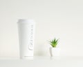 White coffee cup and green potted plant Royalty Free Stock Photo