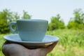 White coffee cup in hand in nature.Coffee time Royalty Free Stock Photo