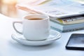 white coffee cup in morning with newspaper and book on table. Royalty Free Stock Photo